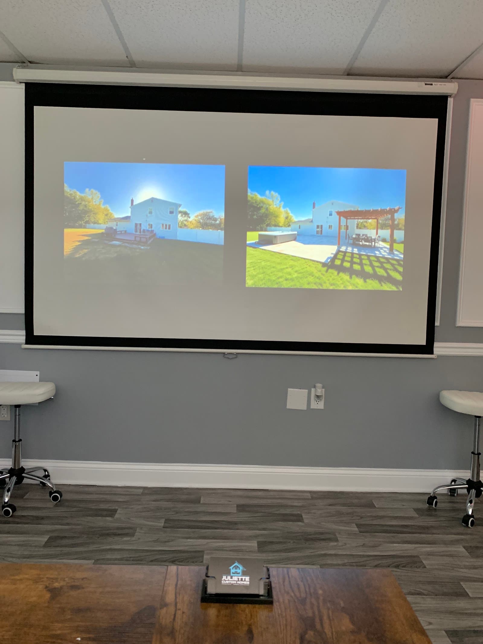 The AI Showroom: a projector screen showing 3D home concepts, with seating for the design consultation.